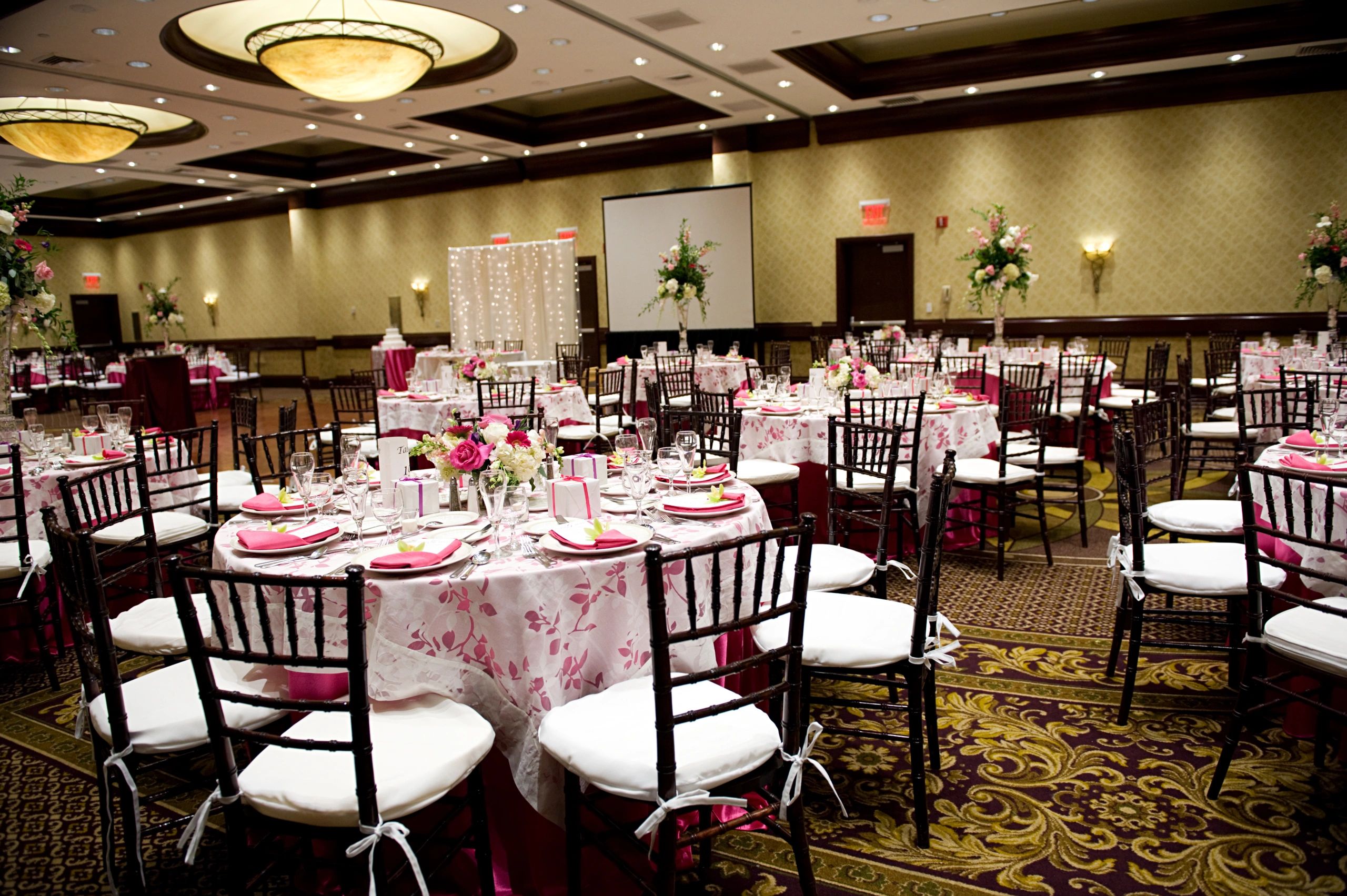 Reception tables arranged with coordinated linens for an event