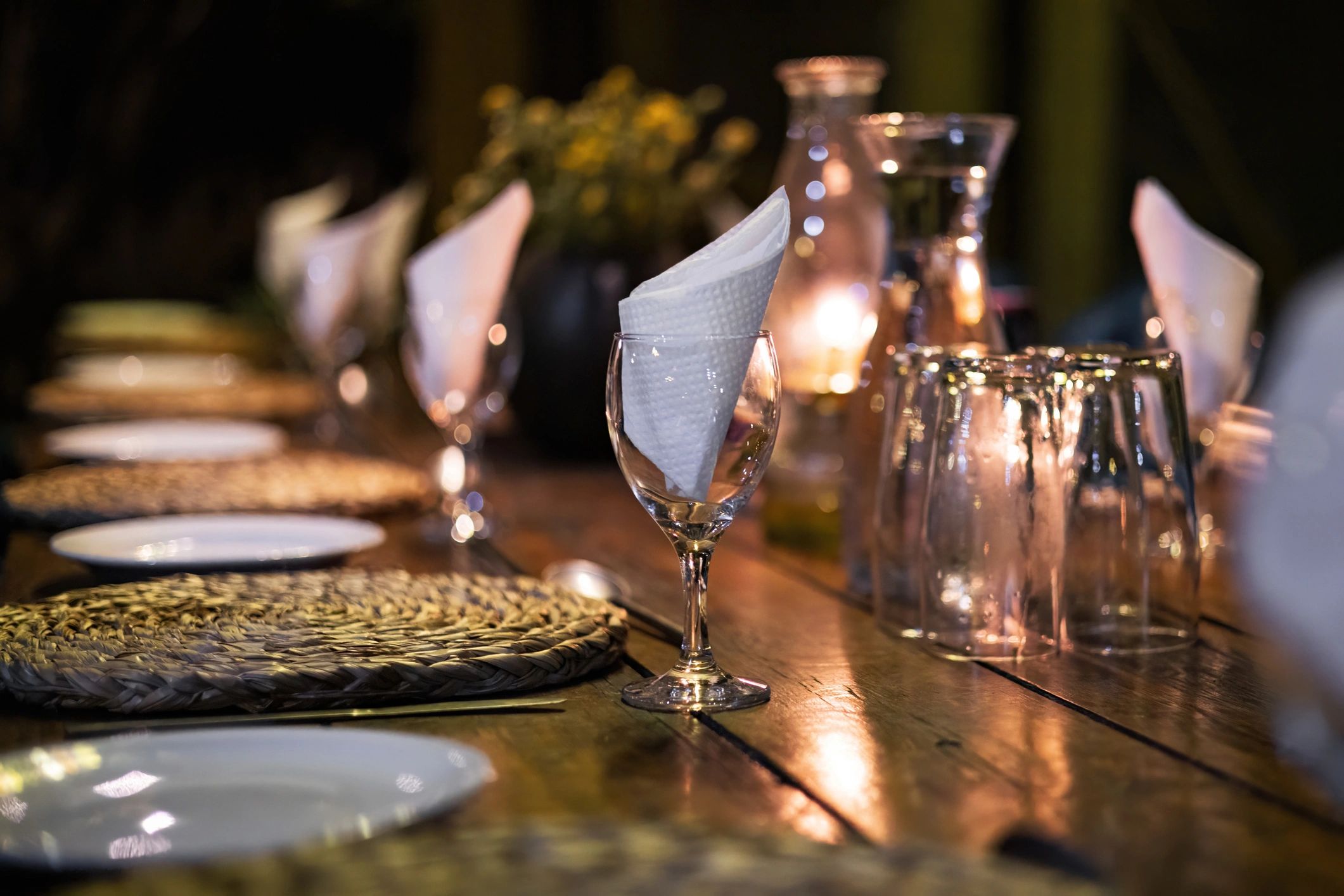 Outdoor dining table with candles and place settings