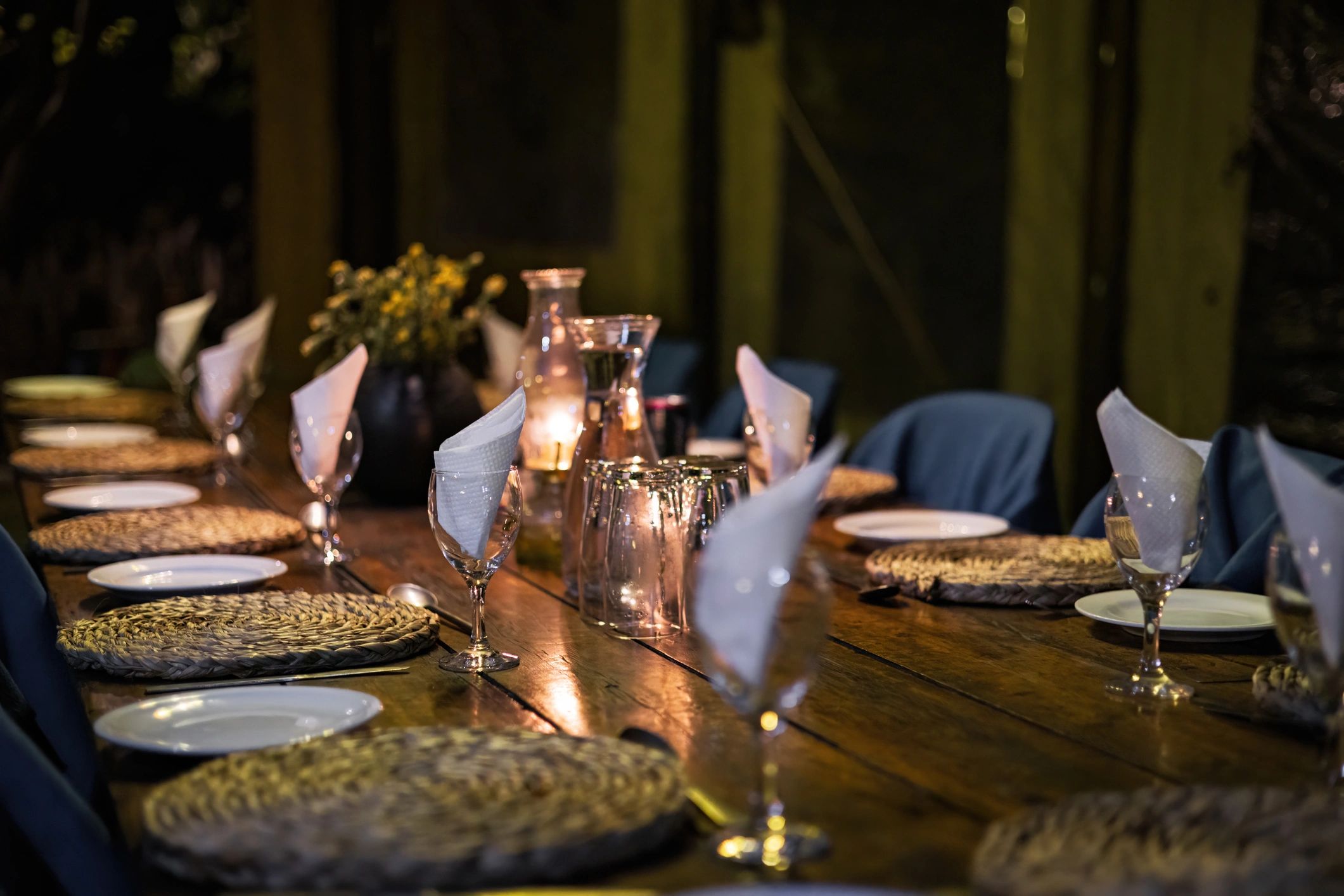Candlelit dining table prepared for guests